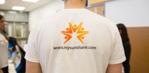 Man with a sunshare shirt on