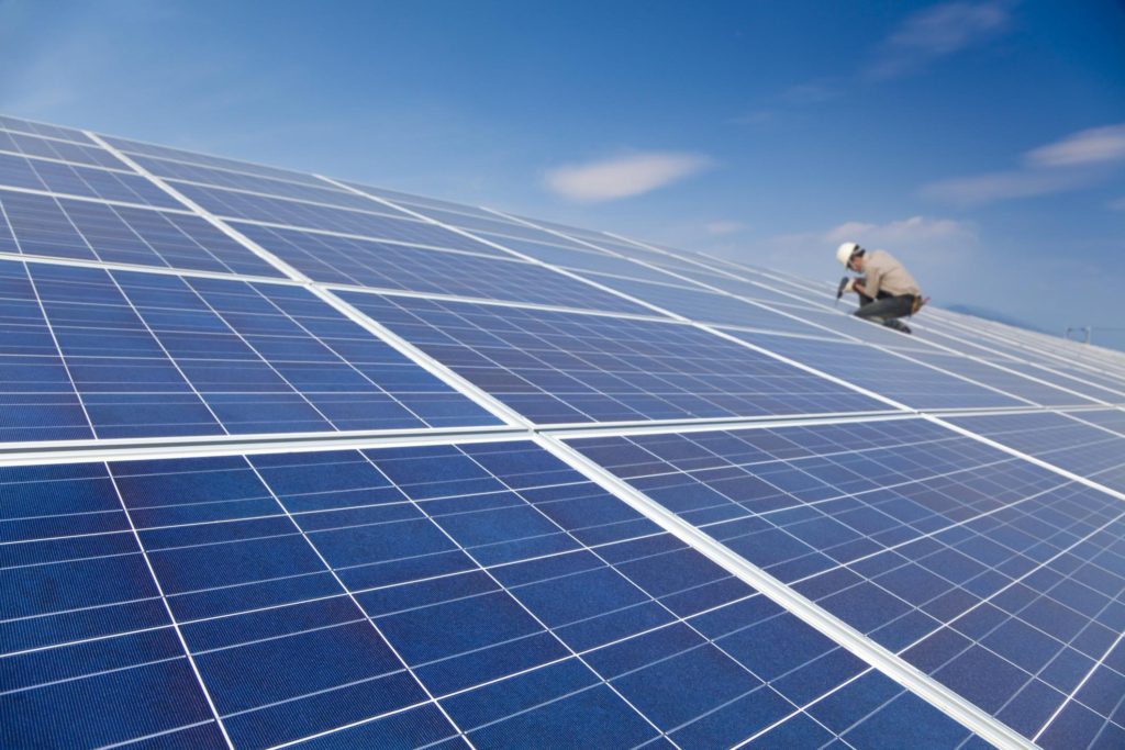 Worker on a solar panel