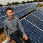 Man sitting on a solar panels