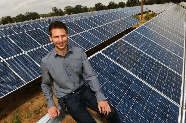 Man sitting on a solar panels