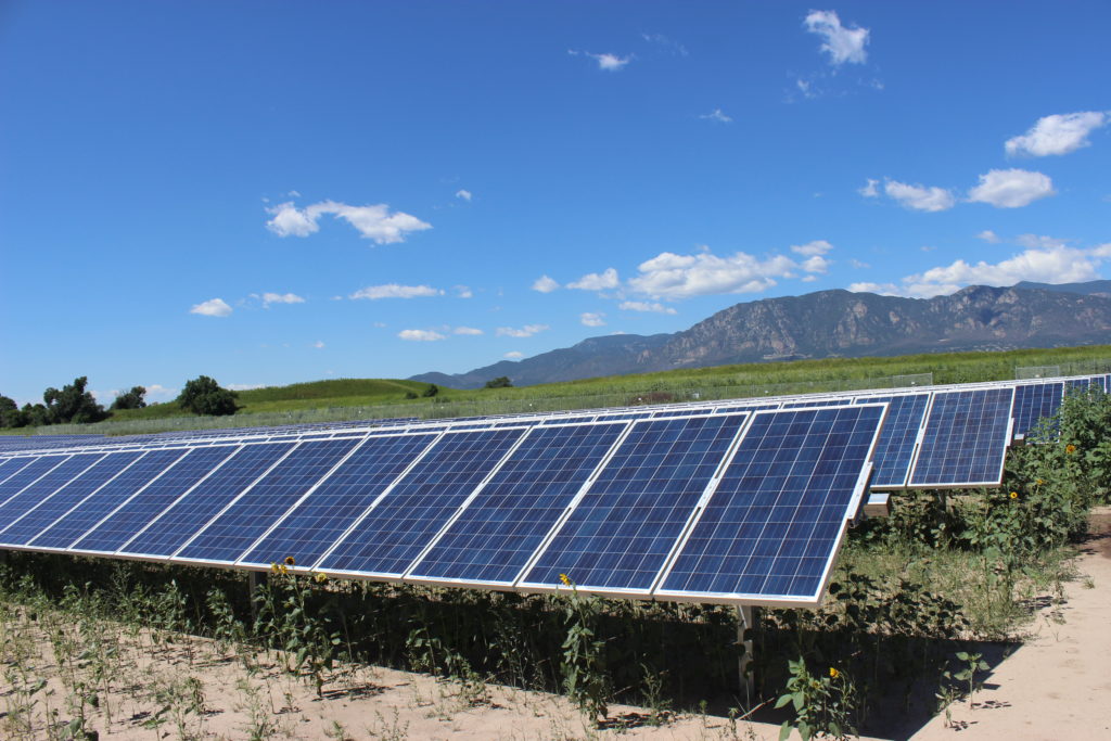 Solar panels in front of mountains