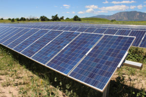 Rows of solar panels by mountains