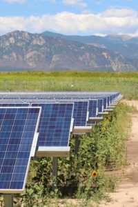 Rows of solar panels by mountains