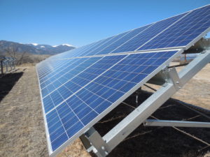 close up of a solar panel in front of mountains